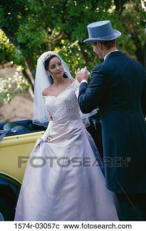 Groom holding his bride's hand View Large Photo Image Stock Image - Groom holding his bride's hand. Fotosearch