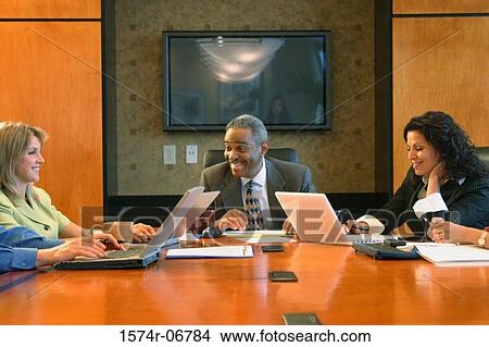 Group of business executives sitting in a conference room View Large Photo Image Picture - Group of business executives sitting in a conference room. Fotosearch