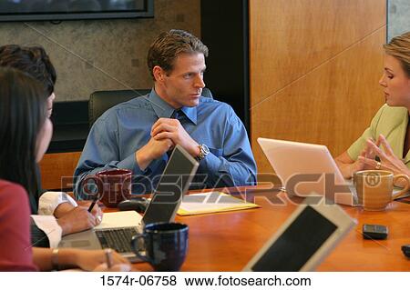 Group of business executives sitting in a conference room View Large Photo Image Stock Photo - Group of business executives sitting in a conference room. Fotosearch