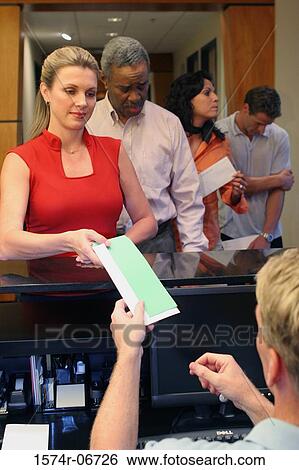 Group of business executives standing in a row at a bank counter View Large Photo Image Stock Photograph - Group of business executives standing in a row at a bank counter. Fotosearch