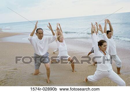 Group of people exercising on the beach View Large Photo Image Stock Image - Group of people exercising on the beach. Fotosearch