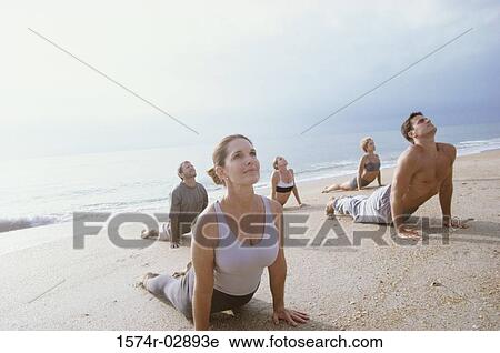 Group of people exercising on the beach View Large Photo Image Stock Image - Group of people exercising on the beach. Fotosearch