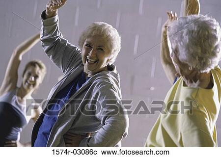 Stock Image - Group of senior women exercising in a health club. Fotosearch