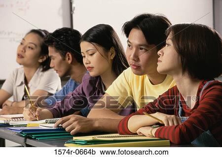 Group of teenagers sitting in a classroom View Large Photo Image Stock Image - Group of teenagers sitting in a classroom. Fotosearch