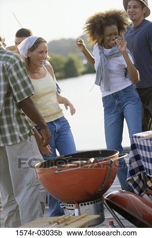 Group of young people at a barbecue View Large Photo Image Stock Image - Group of young people at a barbecue. Fotosearch