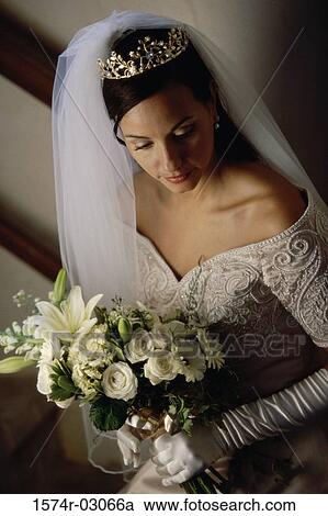 High angle view of a bride holding a bouquet of flowers View Large Photo Image Stock Image - High angle view of a bride holding a bouquet of flowers. Fotosearch