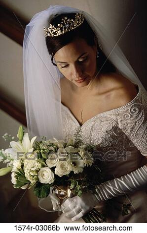 High angle view of a bride holding a bouquet of flowers View Large Photo Image Stock Image - High angle view of a bride holding a bouquet of flowers. Fotosearch