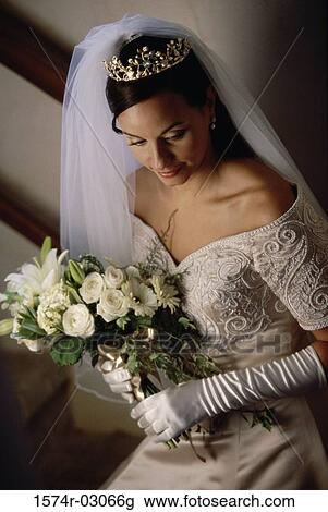 High angle view of a bride holding a bouquet of flowers View Large Photo Image Stock Image - High angle view of a bride holding a bouquet of flowers. Fotosearch