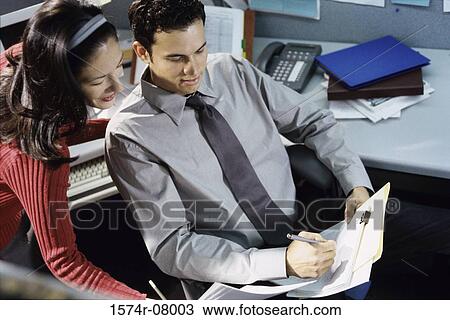 High angle view of a businessman and a businesswoman discussing a report. View Large Photo Image Stock Image - High angle view of a businessman and a businesswoman discussing a report.. Fotosearch