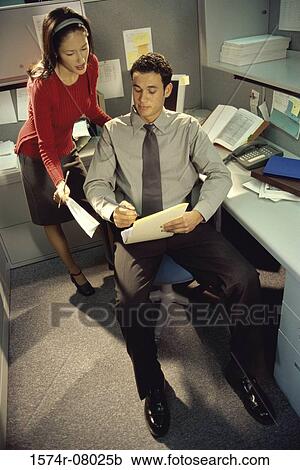 High angle view of a businessman and a businesswoman discussing a report View Large Photo Image Stock Image - High angle view of a businessman and a businesswoman discussing a report. Fotosearch