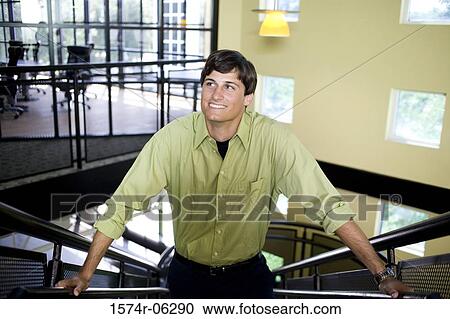 High angle view of a businessman standing on a staircase View Large Photo Image Stock Image - High angle view of a businessman standing on a staircase. Fotosearch