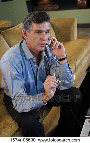 High angle view of a businessman talking on a mobile phone View Large Photo Image Stock Image - High angle view of a businessman talking on a mobile phone. Fotosearch