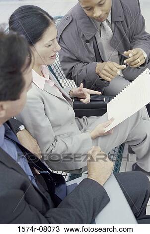 Stock Image - High angle view of a businesswoman and two businessmen. Fotosearch