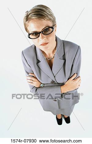 Stock Image - High angle view of a businesswoman standing with her arms folded. Fotosearch