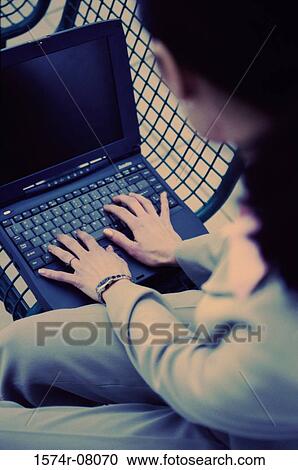 High angle view of a businesswoman operating a laptop View Large Photo Image Stock Image - High angle view of a businesswoman operating a laptop. Fotosearch