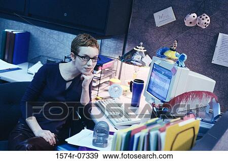 Stock Photo - High angle view of a businesswoman sitting in an office. Fotosearch