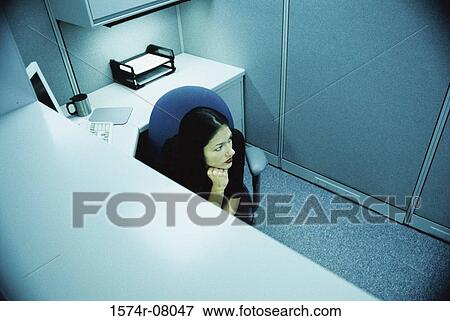 Stock Photo - High angle view of a businesswoman seated in an office. Fotosearch