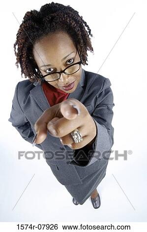 Stock Photograph - High angle view of a businesswoman pointing. Fotosearch