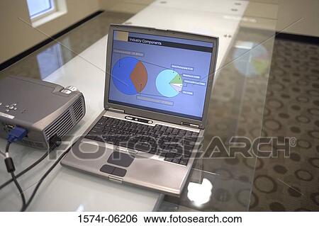 Stock Photograph - High angle view of a laptop and projection equipment in a conference room. Fotosearch