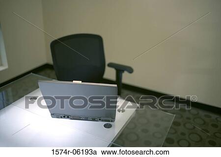 High angle view of a laptop on a desk in an office View Large Photo Image Stock Image - High angle view of a laptop on a desk in an office. Fotosearch