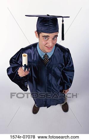 High angle view of a young male graduate holding a diploma View Large Photo Image Stock Photo - High angle view of a young male graduate holding a diploma. Fotosearch