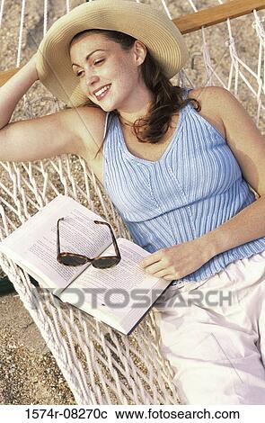 High angle view of a young woman lying in a hammock View Large Photo Image Stock Image - High angle view of a young woman lying in a hammock. Fotosearch