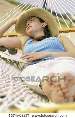High angle view of a young woman lying in a hammock View Large Photo Image Stock Image - High angle view of a young woman lying in a hammock. Fotosearch