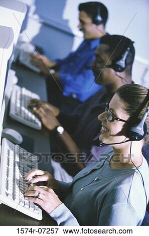 Stock Photo - High angle view of customer service representatives working. Fotosearch
