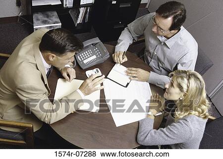 High angle view of three business executives in a meeting View Large Photo Image Stock Photo - High angle view of three business executives in a meeting. Fotosearch