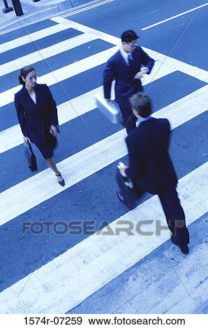 High angle view of two businessmen and a businesswoman crossing the street View Large Photo Image Stock Photo - High angle view of two businessmen and a businesswoman crossing the street. Fotosearch