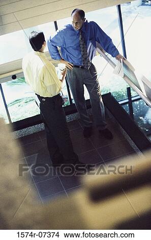Picture - High angle view of two businessmen discussing. Fotosearch