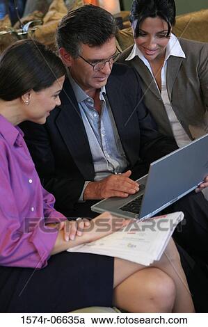 High angle view of two businesswomen sitting with a businessman View Large Photo Image Stock Image - High angle view of two businesswomen sitting with a businessman. Fotosearch
