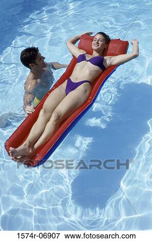High angle view of young couple together in a swimming pool View Large Photo Image Stock Photo - High angle view of young couple together in a swimming pool. Fotosearch