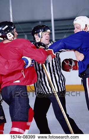 Ice hockey referee attempting to break up a fight View Large Photo Image Stock Photo - Ice hockey referee attempting to break up a fight. Fotosearch