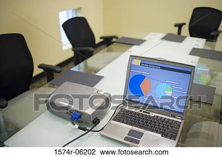 Stock Image - Laptop and projection equipment in a conference room. Fotosearch