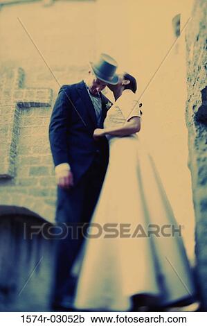 Low angle view of a bride whispering to her groom View Large Photo Image Stock Image - Low angle view of a bride whispering to her groom. Fotosearch