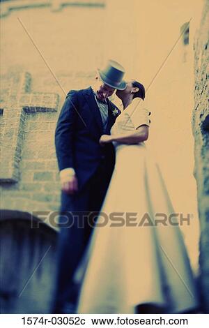 Low angle view of a bride whispering to her groom View Large Photo Image Stock Image - Low angle view of a bride whispering to her groom. Fotosearch