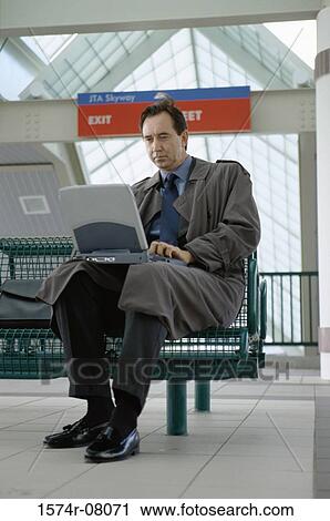 Low angle view of a businessman working on a laptop View Large Photo Image Stock Image - Low angle view of a businessman working on a laptop. Fotosearch