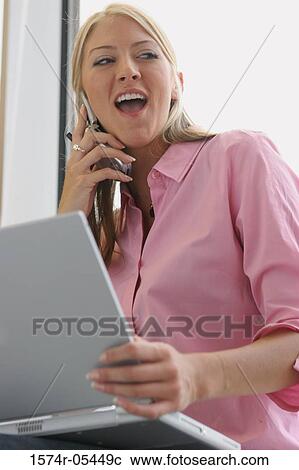 Low angle view of a businesswoman using a mobile phone View Large Photo Image Stock Image - Low angle view of a businesswoman using a mobile phone. Fotosearch