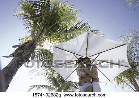 Low angle view of a young couple embracing on the beach View Large Photo Image Stock Image - Low angle view of a young couple embracing on the beach. Fotosearch