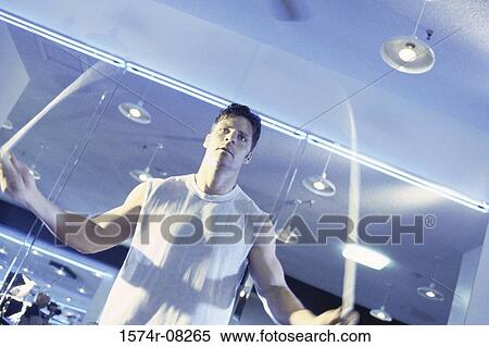 Low angle view of a young man jumping rope View Large Photo Image Stock Photography - Low angle view of a young man jumping rope. Fotosearch