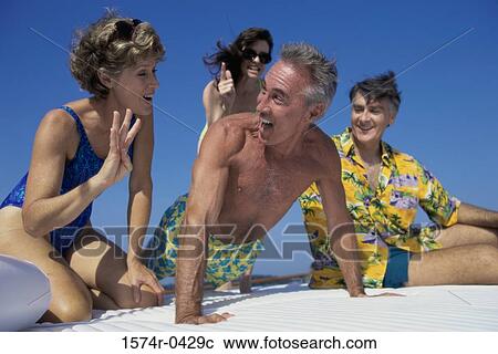 Low angle view of two mature couples on a boat View Large Photo Image Stock Image - Low angle view of two mature couples on a boat. Fotosearch