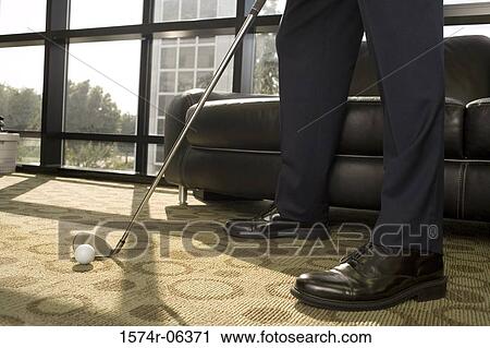 Low section view of a businessman playing golf in an office View Large Photo Image Stock Image - Low section view of a businessman playing golf in an office. Fotosearch
