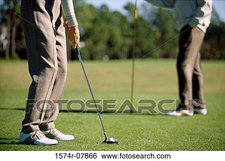 Low section view of two people playing golf View Large Photo Image Stock Photograph - Low section view of two people playing golf. Fotosearch