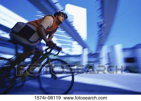 Male messenger riding a bicycle View Large Photo Image Stock Photo - Male messenger riding a bicycle. Fotosearch