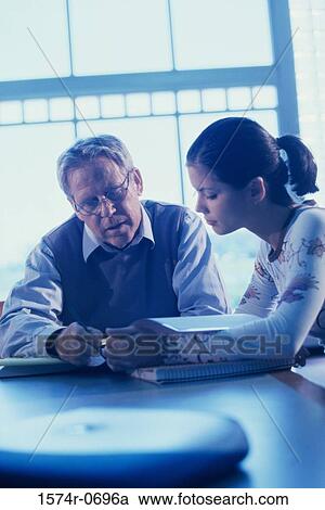 Male teacher teaching a girl View Large Photo Image Stock Image - Male teacher teaching a girl. Fotosearch