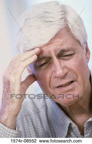 Man holding his head with a headache View Large Photo Image Stock Image - Man holding his head with a headache. Fotosearch