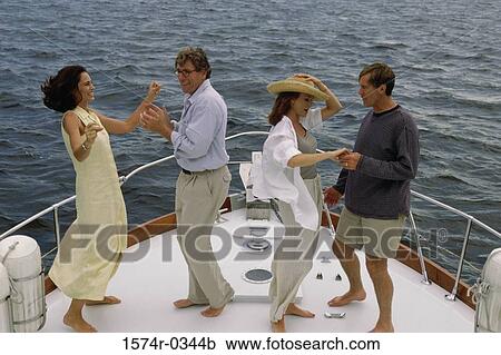 Mid adult couple and a mature couple dancing on the bow of a boat View Large Photo Image Stock Image - Mid adult couple and a mature couple dancing on the bow of a boat. Fotosearch