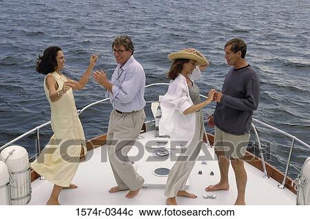 Mid adult couple and a mature couple dancing on the bow of a boat View Large Photo Image Stock Image - Mid adult couple and a mature couple dancing on the bow of a boat. Fotosearch