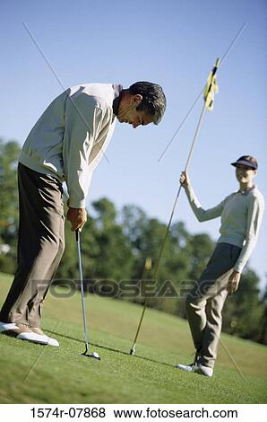 Mid adult couple playing golf View Large Photo Image Stock Photo - Mid adult couple playing golf. Fotosearch